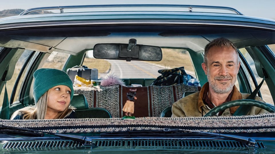 Sadie and her father Tom on the road in the family station wagon